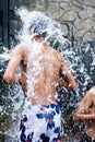 Kids enjoying and having fun with Ravana waterfall, Sri Lanka